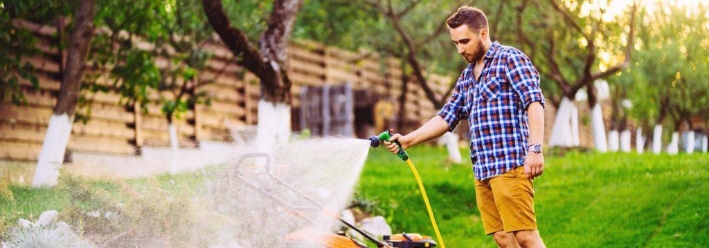 man watering lawn