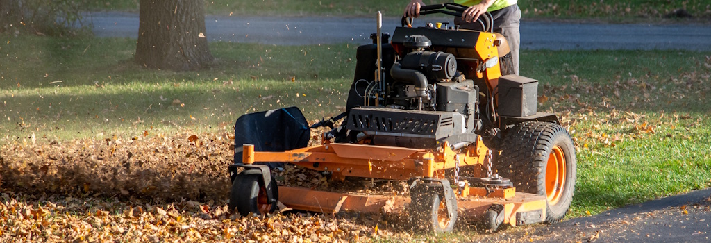 mowing crew mowing yard in fall